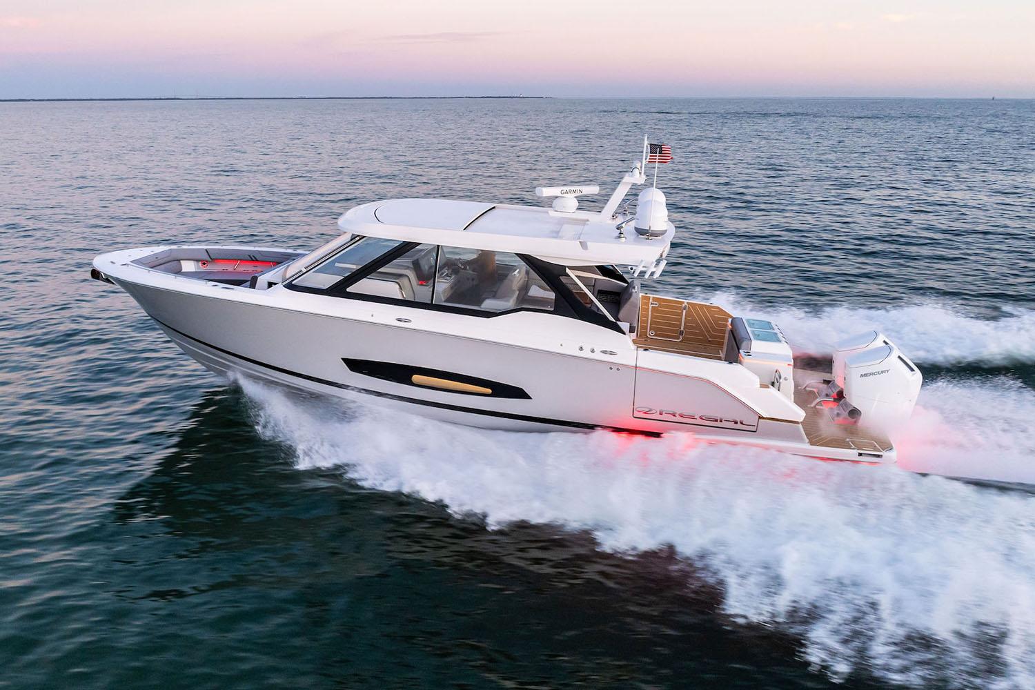 Regal outboard sport yacht cruising at sunset on the Florida Gulf Coast